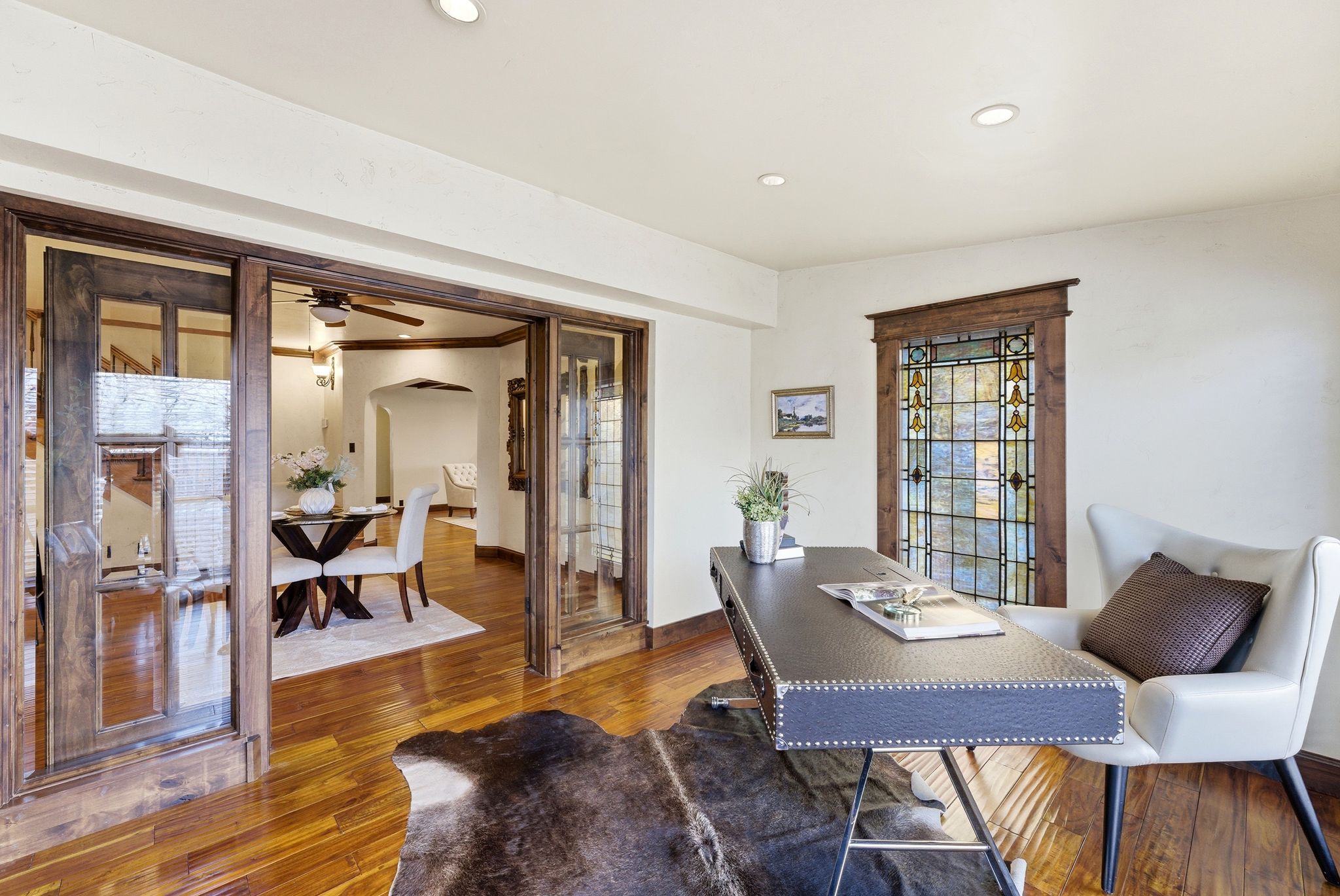 Office area with hardwood / wood-style floors, recessed lighting, a ceiling fan, and arched walkways