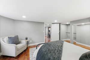 Bedroom with wood finished floors and recessed lighting