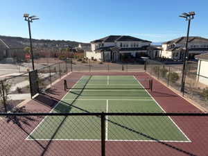 View of tennis court featuring a residential view