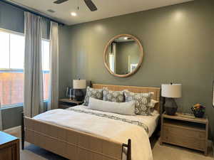 Carpeted bedroom featuring a ceiling fan and recessed lighting