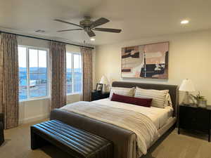 Carpeted bedroom featuring a ceiling fan and recessed lighting