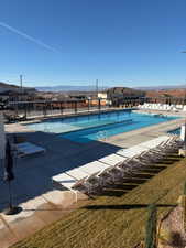 Community pool featuring a mountain view and a patio