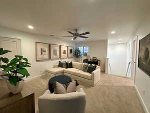 Living room featuring carpet flooring, recessed lighting, and ceiling fan