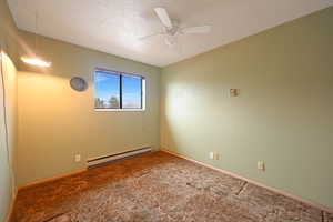 Unfurnished room with a baseboard heating unit, a textured ceiling, carpet, and ceiling fan