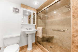 Full bathroom featuring a stall shower and a textured ceiling