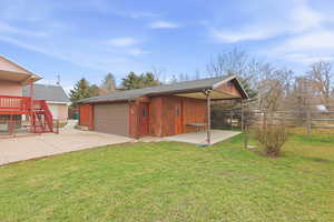 View of home's exterior featuring an outbuilding, a garage, and roof with shingles
