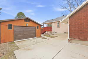 Detached garage featuring concrete driveway