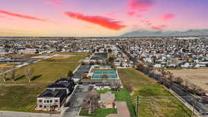 Aerial perspective of suburban area featuring a mountainous background, digitally enhanced