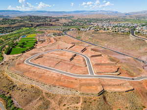 Aerial view of property and surrounding area with a water and mountain view