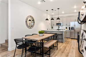 Dining room featuring light wood-style flooring and recessed lighting