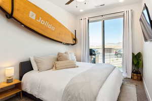 Carpeted bedroom featuring access to exterior, a ceiling fan, and recessed lighting