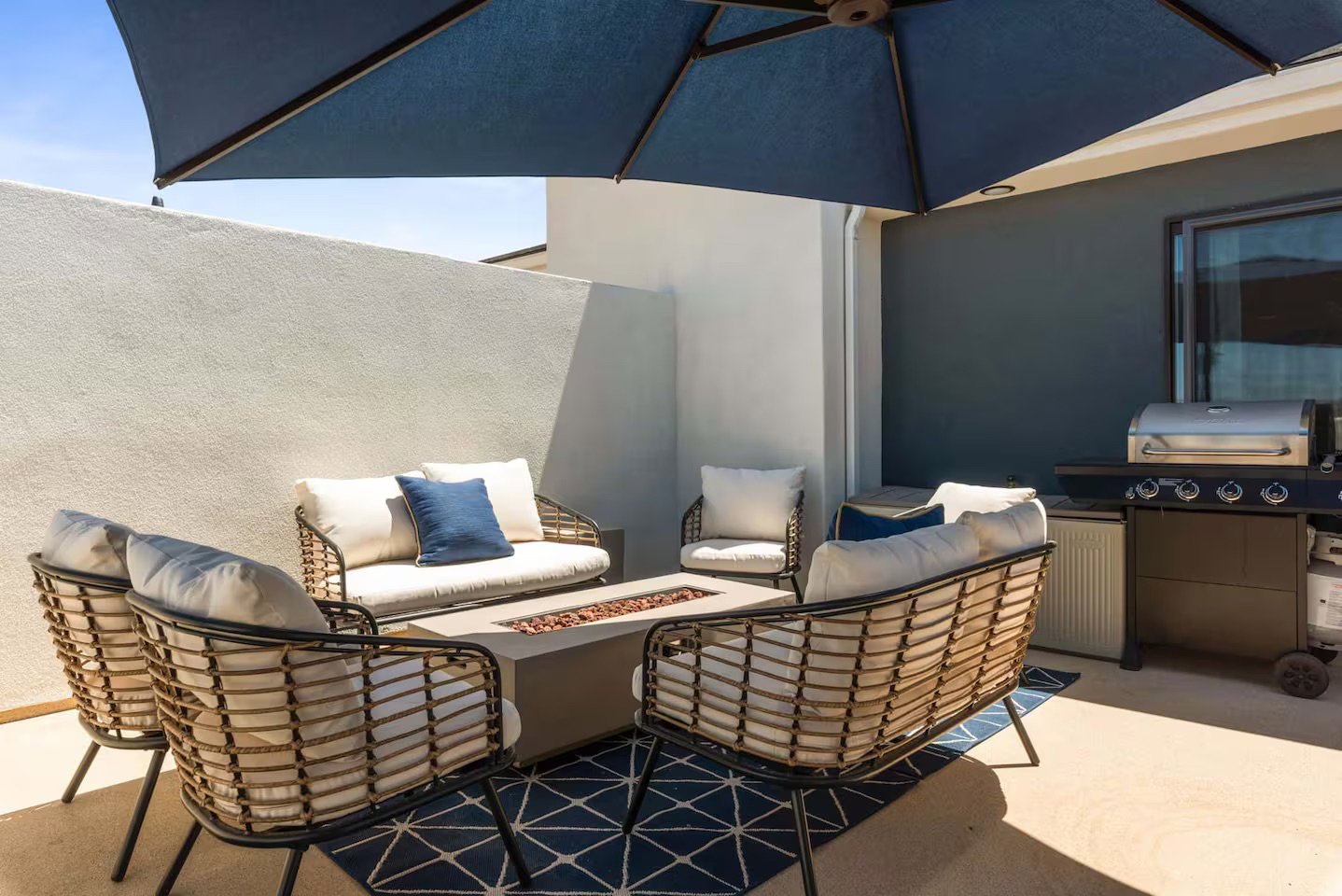 View of patio featuring an outdoor living space with a fire pit and a grill