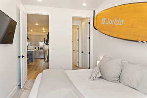 Bedroom featuring recessed lighting, stainless steel fridge, and light wood-style flooring