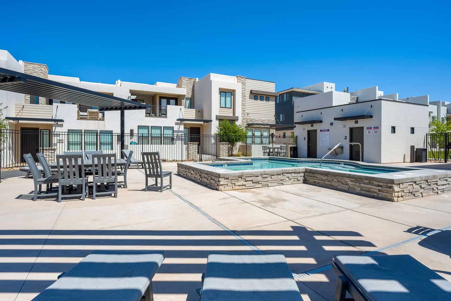 View of patio / terrace with a jacuzzi and a residential view