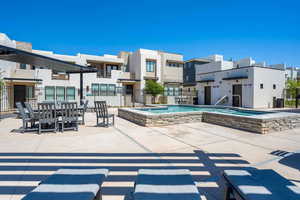 View of patio / terrace with a jacuzzi and a residential view
