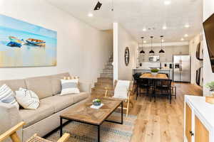 Living area featuring light wood finished floors, recessed lighting, and ceiling fan