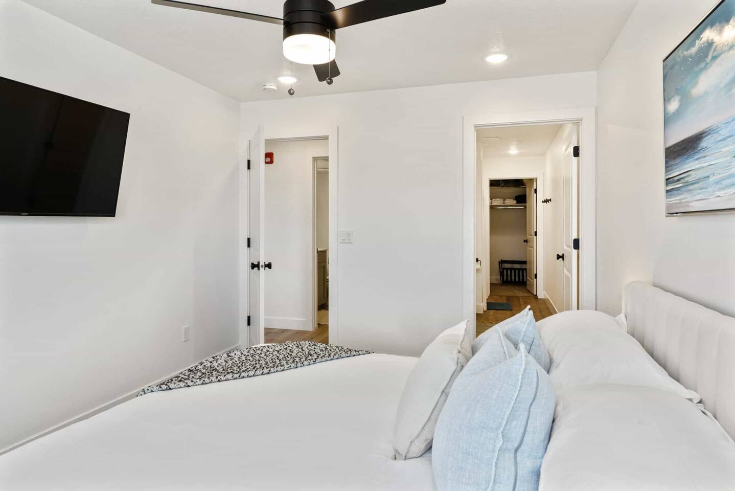Bedroom featuring ceiling fan, recessed lighting, and ensuite bath