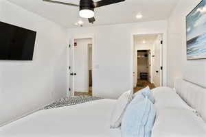 Bedroom featuring ceiling fan, recessed lighting, and ensuite bath