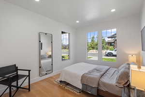 Bedroom with light wood finished floors and recessed lighting