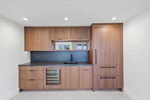 Indoor wet bar featuring modern cabinets, wood finish cabinetry, wine cooler, open shelves, and recessed lighting