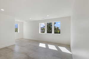 Empty room with baseboards and recessed lighting