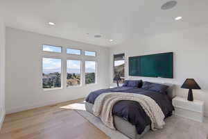 Bedroom with light wood-type flooring and recessed lighting