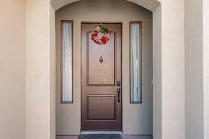 Property entrance featuring stucco siding