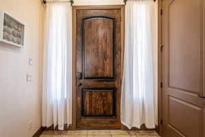 Entryway featuring baseboards and tile patterned floors
