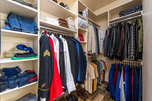 Walk in closet featuring dark wood-style floors