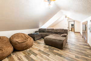 Living room featuring light wood-type flooring and a ceiling fan
