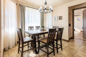 Dining room featuring hanging lights and light tile patterned floors