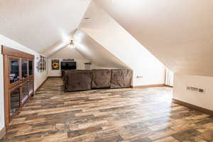 Additional living space featuring wood finished floors and baseboards
