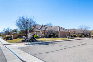 View of front of house featuring stucco siding, a tiled roof, and an attached garage