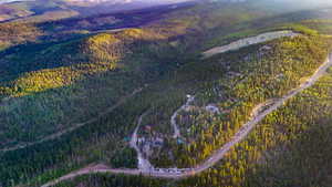 Aerial view of property's location with a heavily wooded area