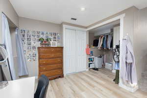 Bedroom with a closet and light wood-type flooring