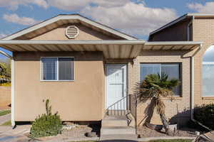 View of front facade with brick siding and stucco siding