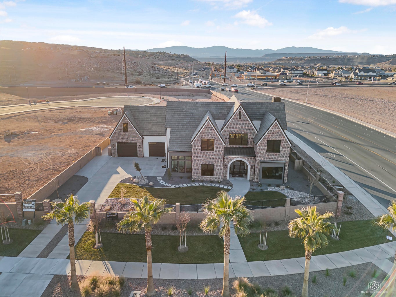 Aerial view of property and surrounding area with a mountain backdrop