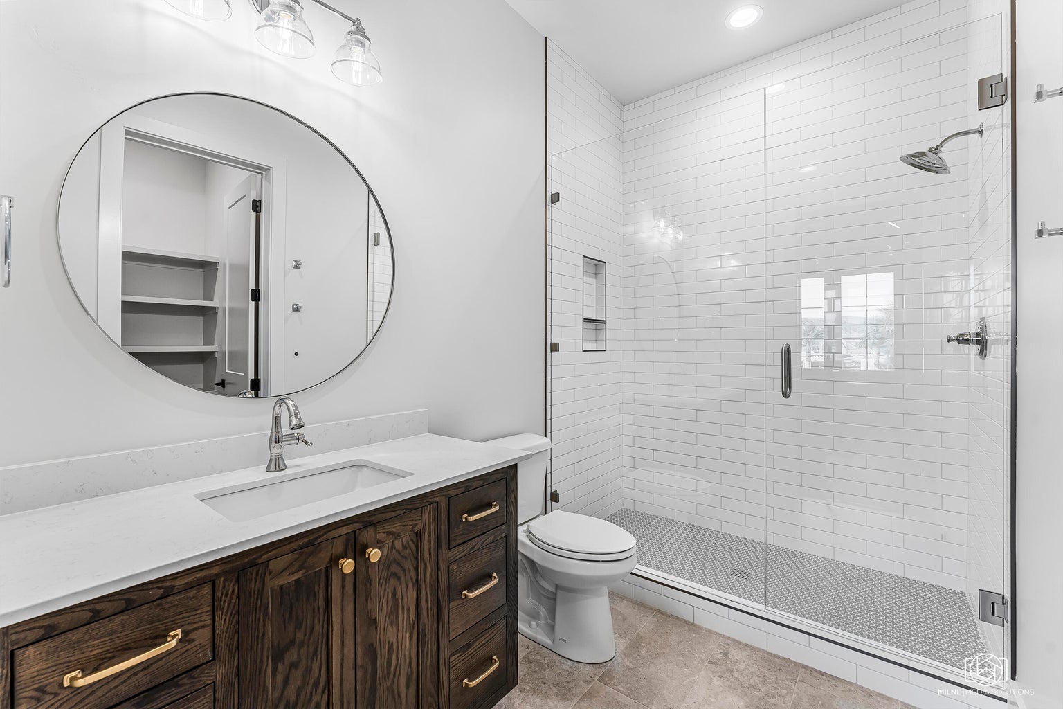 Bathroom with a shower stall, vanity, and recessed lighting