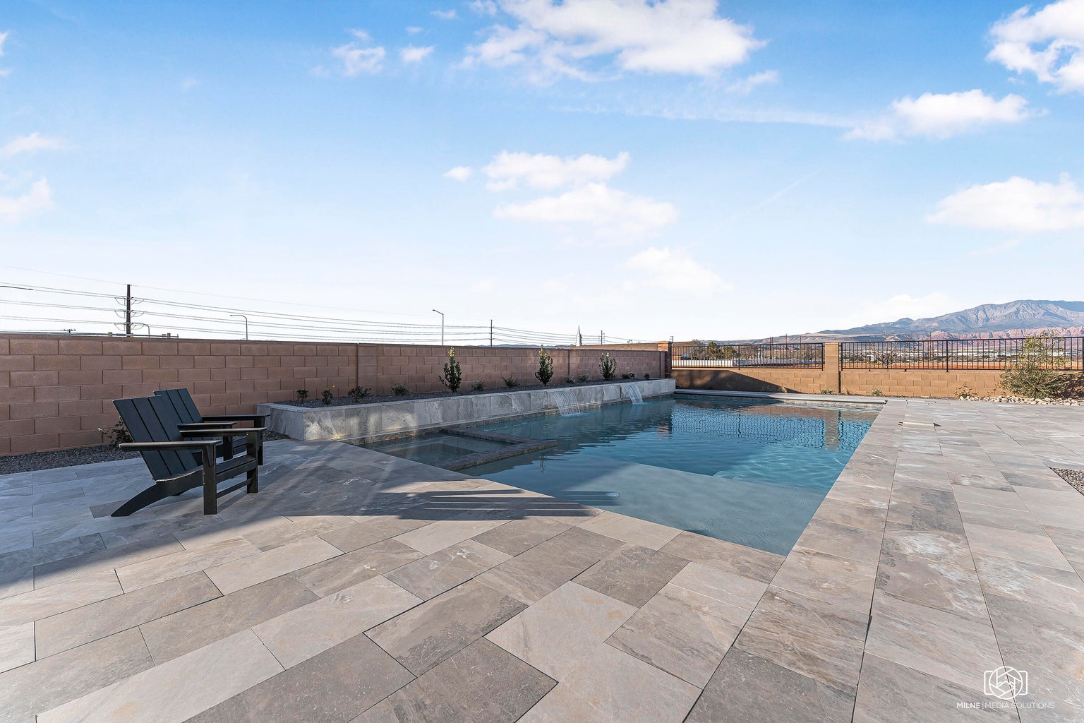 Relaxing pool / spa featuring a fenced backyard, a patio, and a mountain view