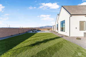 Fenced backyard featuring a mountain view, a patio, and a pool
