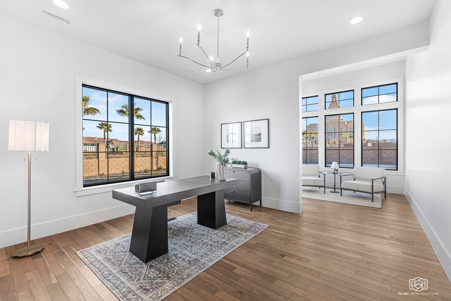 Office featuring light wood finished floors and hanging lights