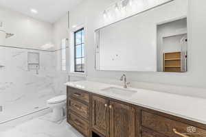 Bathroom with vanity, a marble finish shower, light marble finish floors, recessed lighting, and a spacious closet
