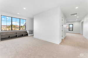 Spare room featuring light colored carpet and recessed lighting