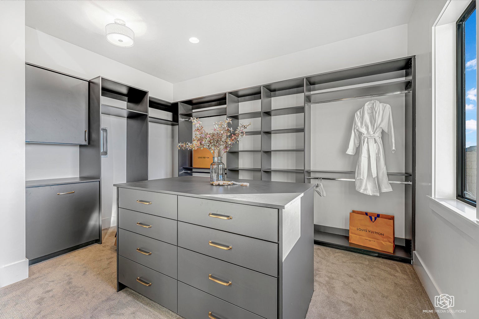Walk in closet featuring light colored carpet
