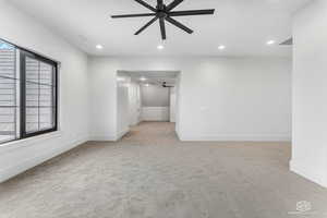 Unfurnished room featuring a ceiling fan, light colored carpet, and recessed lighting