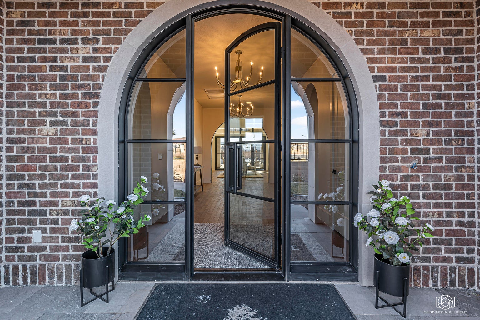 View of exterior entry featuring brick siding