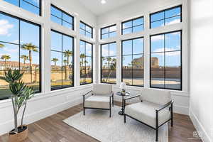 Sunroom with wood-type flooring, plenty of natural light, and recessed lighting