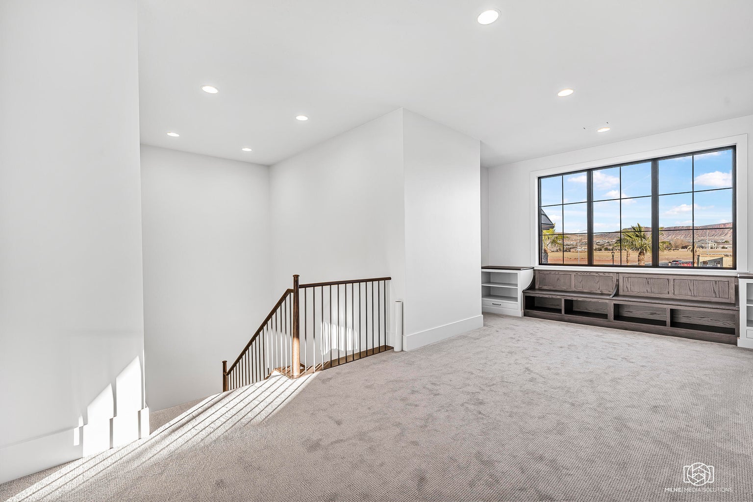 Carpeted empty room with recessed lighting