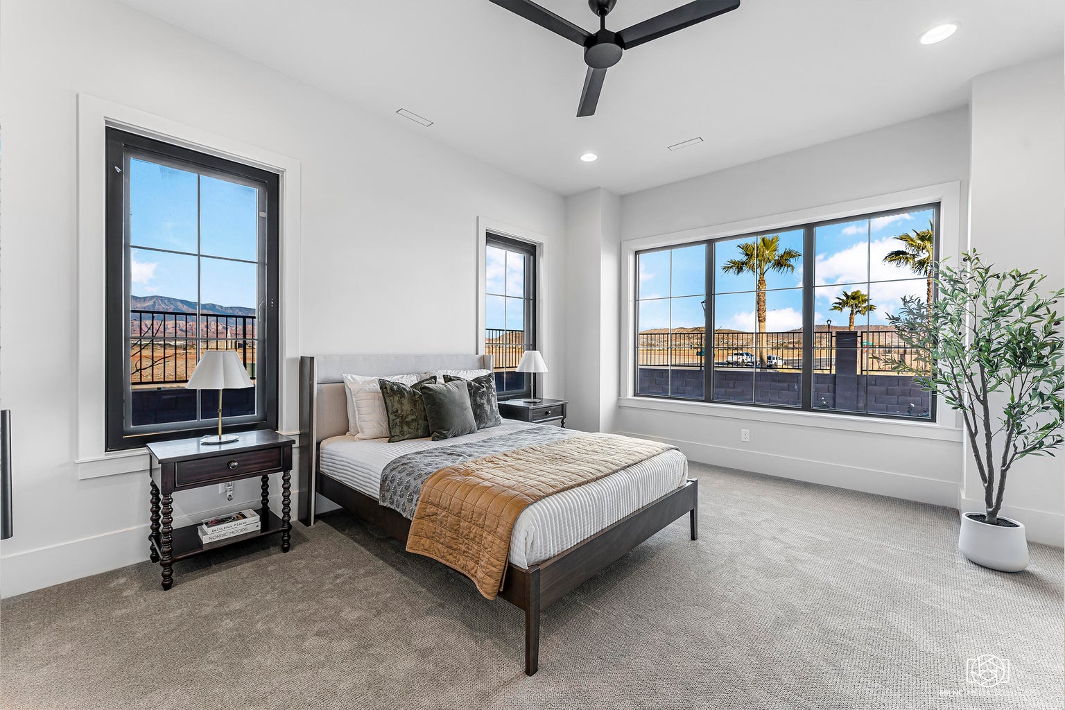 Carpeted bedroom with multiple windows, a ceiling fan, and recessed lighting