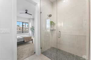 Bathroom featuring connected bathroom, a stall shower, light colored carpet, ceiling fan, and recessed lighting